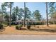 Brick house with blue shutters, double doors, and manicured lawn at 5 Jessamine St., Andrews, SC 29510