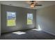 Spacious bedroom with neutral walls, carpeted floors, and large windows at 557 Honeyhill Loop, Conway, SC 29526