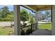 Covered front porch with black metal railing, offering a view of the neighborhood and landscaping at 2608 Painted Trillium Ct., Myrtle Beach, SC 29579