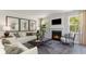 Cozy living room features a fireplace, plush sofas, and large windows at 133 Fair Meadow Ct., Loris, SC 29569
