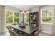 Bright dining room featuring a table with six chairs and large windows at 133 Fair Meadow Ct., Loris, SC 29569