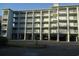 Three-story building with parking and balconies at 14290 Ocean Hwy. # 103, Pawleys Island, SC 29585