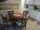 Small dining area with round table and four chairs at 14290 Ocean Hwy. # 103, Pawleys Island, SC 29585