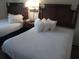Cozy guest bedroom with two twin beds and nightstand at 14290 Ocean Hwy. # 103, Pawleys Island, SC 29585