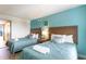 Guest bedroom with two beds, light teal walls, and wood headboards at 1501 S Ocean Blvd. # 936, Myrtle Beach, SC 29577