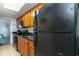 Kitchen with black appliances and wood cabinets at 1501 S Ocean Blvd. # 936, Myrtle Beach, SC 29577