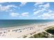 Expansive beach view with people and blue umbrellas at 1501 S Ocean Blvd. # 936, Myrtle Beach, SC 29577