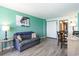 Living room features a sofa, dining area, and wood-look floors at 1501 S Ocean Blvd. # 936, Myrtle Beach, SC 29577