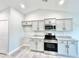 Modern kitchen with grey cabinets and stainless steel appliances at 1424 Nathan Dr., Loris, SC 29569