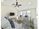 Spacious living room with light gray sofas and a large TV at 1424 Nathan Dr., Loris, SC 29569