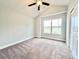 Simple bedroom with large window and grey carpet at 1424 Nathan Dr., Loris, SC 29569