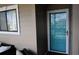 Light teal front door with glass panels, offering a welcoming entry to this coastal condo at 206 60Th Ave. N # 203, North Myrtle Beach, SC 29582