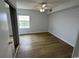 Bright bedroom with wood-look floors and a large window at 2273 Huntingdon Dr. # J, Surfside Beach, SC 29575
