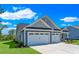 Two-car garage with side entry, landscaping, and a gray exterior at 120 Little Cedar Dr., Loris, SC 29569