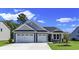Curb appeal abounds with this charming one-story home showcasing a two-car garage and well-manicured lawn at 120 Little Cedar Dr., Loris, SC 29569