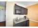 Small kitchenette with microwave, sink, and granite countertop at 1501 S Ocean Blvd. # 927, Myrtle Beach, SC 29577
