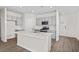 Open kitchen featuring gray cabinets, stainless steel appliances, and an island at 3047 Deerberry Place, Longs, SC 29568