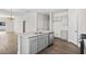 Modern kitchen with island, stainless steel appliances, and gray cabinets at 3047 Deerberry Place, Longs, SC 29568
