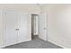 Bright bedroom with grey carpet, double doors to closet and access to another room at 3047 Deerberry Place, Longs, SC 29568