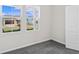 Bright bedroom with gray carpet and two windows at 3047 Deerberry Place, Longs, SC 29568