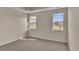 Well-lit bedroom with carpet flooring and two windows at 3009 Deerberry Place, Longs, SC 29568