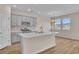 Modern kitchen with gray cabinets, white quartz island, and stainless steel appliances at 3009 Deerberry Place, Longs, SC 29568