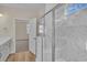 Large walk-in shower with marble tile and built-in seat at 3009 Deerberry Place, Longs, SC 29568