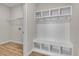 White cubby with storage shelves, hooks, and bench at 3009 Deerberry Place, Longs, SC 29568