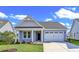 Charming one-story house with gray siding and a white garage door at 3009 Deerberry Place, Longs, SC 29568