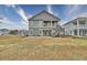 Two-story home with gray siding, a back patio, and a grassy yard at 202 Palmetto Harbour Dr., North Myrtle Beach, NC 29582