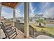 Inviting front porch with rocking chairs, offering a view of the neighborhood at 202 Palmetto Harbour Dr., North Myrtle Beach, NC 29582