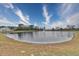 Serene pond view with fountain, lush greenery, and clear blue skies at 202 Palmetto Harbour Dr., North Myrtle Beach, NC 29582