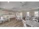 Community room with white tables and chairs, kitchen area, and hardwood floors at Tbd3 Kapalua Loop, Little River, SC 29566