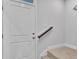 Interior stairs with white door and dark wood handrail at 301 Sandridgebury Dr. # 68, Little River, SC 29566