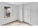 Simple bedroom with neutral walls, carpet flooring, and a door to another room at 301 Sandridgebury Dr. # 68, Little River, SC 29566