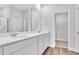 Modern bathroom boasts double vanity, a large mirror, and an adjacent linen closet at 301 Sandridgebury Dr. # 68, Little River, SC 29566