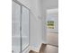 Clean bathroom with a glass shower enclosure and an adjacent bedroom view at 301 Sandridgebury Dr. # 68, Little River, SC 29566