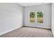 Bright bedroom with neutral walls, carpet flooring, and a window offering natural light at 301 Sandridgebury Dr. # 68, Little River, SC 29566