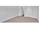 Spacious bedroom with neutral walls, carpet flooring, and an open door to a bathroom at 301 Sandridgebury Dr. # 68, Little River, SC 29566
