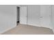 Bright bedroom with neutral walls, carpet flooring, and access to other rooms at 301 Sandridgebury Dr. # 68, Little River, SC 29566