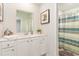 Bathroom with white vanity, shower, and striped curtain at 1151 Flintshire Dr., Myrtle Beach, SC 29579