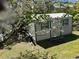 Metal storage shed in backyard with green trim at 12727 Ocean Highway, Pawleys Island, SC 29585