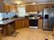 Spacious kitchen with corner sink and stainless steel refrigerator at 12727 Ocean Highway, Pawleys Island, SC 29585
