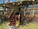Home exterior with stairs leading to a screened porch at 12727 Ocean Highway, Pawleys Island, SC 29585