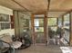 Relaxing screened porch with seating area at 12727 Ocean Highway, Pawleys Island, SC 29585