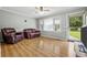 Living room featuring hardwood floors, comfortable seating and access to the backyard at 129 Meadowview Rd., Marion, SC 29571