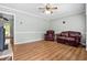 Living room with hardwood floors, leather furniture, and ceiling fan at 129 Meadowview Rd., Marion, SC 29571