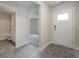 Bright entryway with grey wood-look floors, a half bath, and an open view to the living room at 3850 Lady Bug Dr., Shallotte, NC 28470