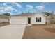 Newly constructed home with a two-car garage and landscaped lawn at 3850 Lady Bug Dr., Shallotte, NC 28470