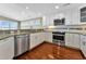 White kitchen with granite countertops and stainless steel appliances at 410 N 28Th Ave. N, North Myrtle Beach, SC 29582